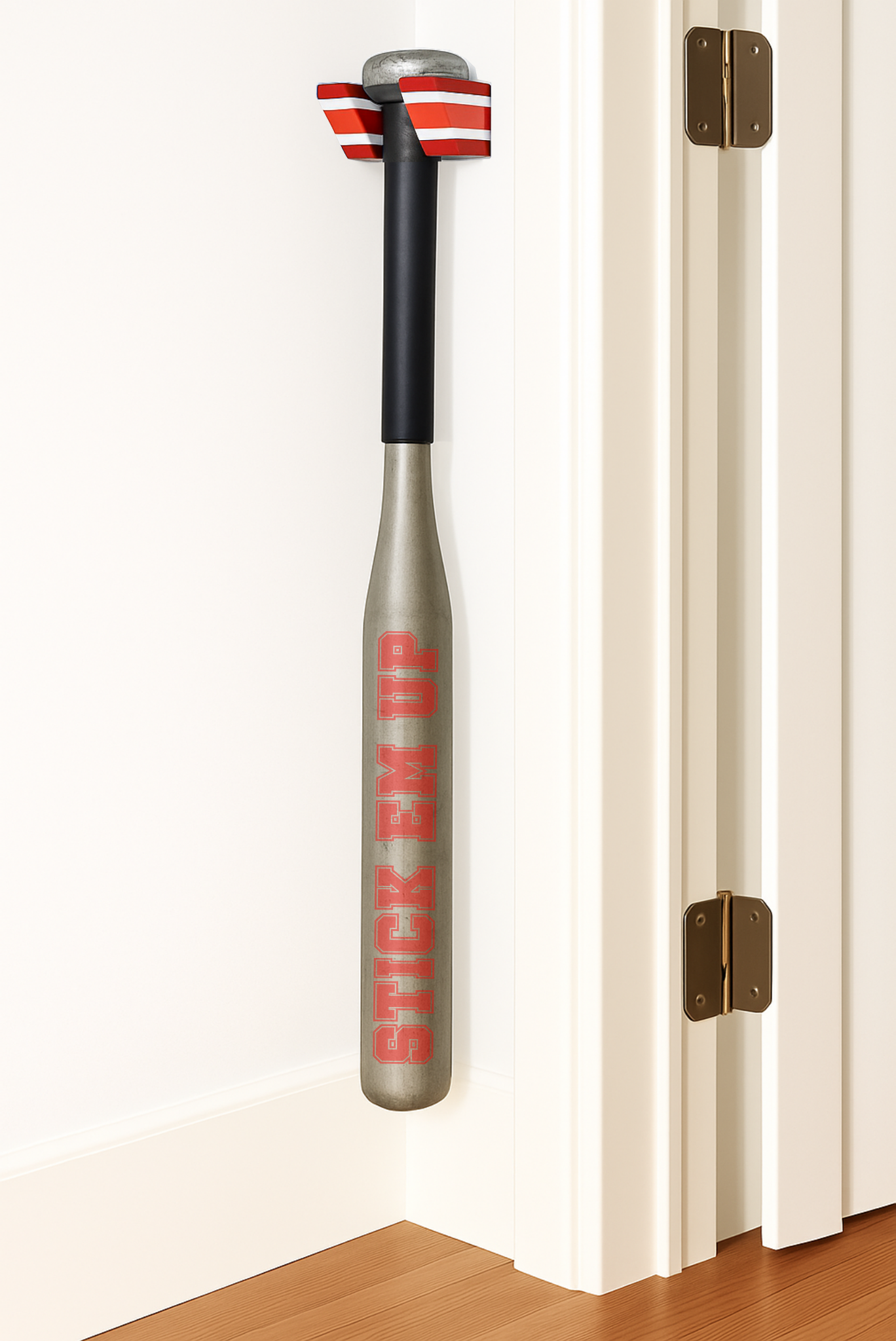 A Red, White, and Red Single Baseball Bat Holder Mounted against a wall near a doorframe.