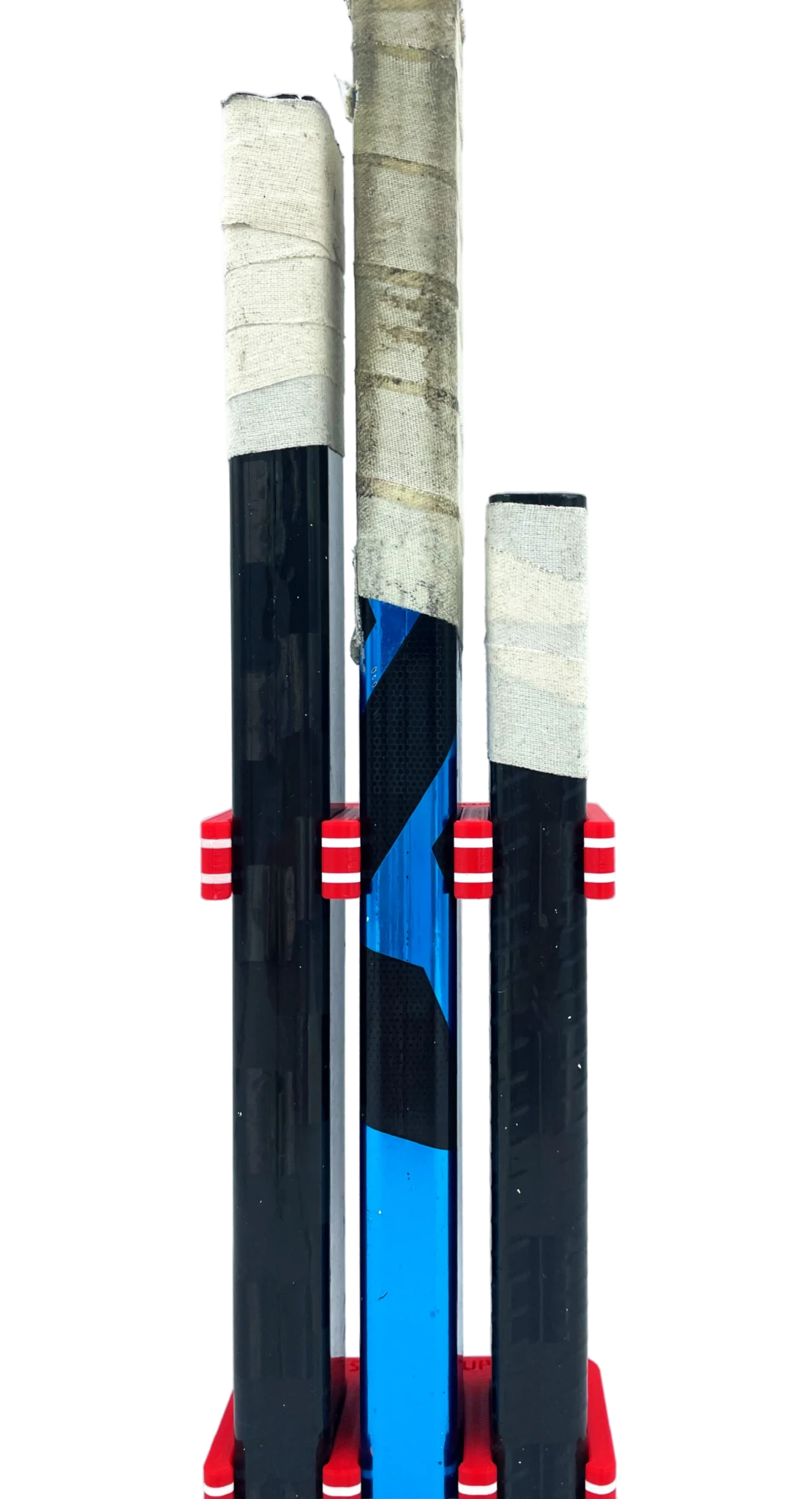 Three hockey sticks gripped with red, white, and red hockey Stick Em Ups on a transparent background