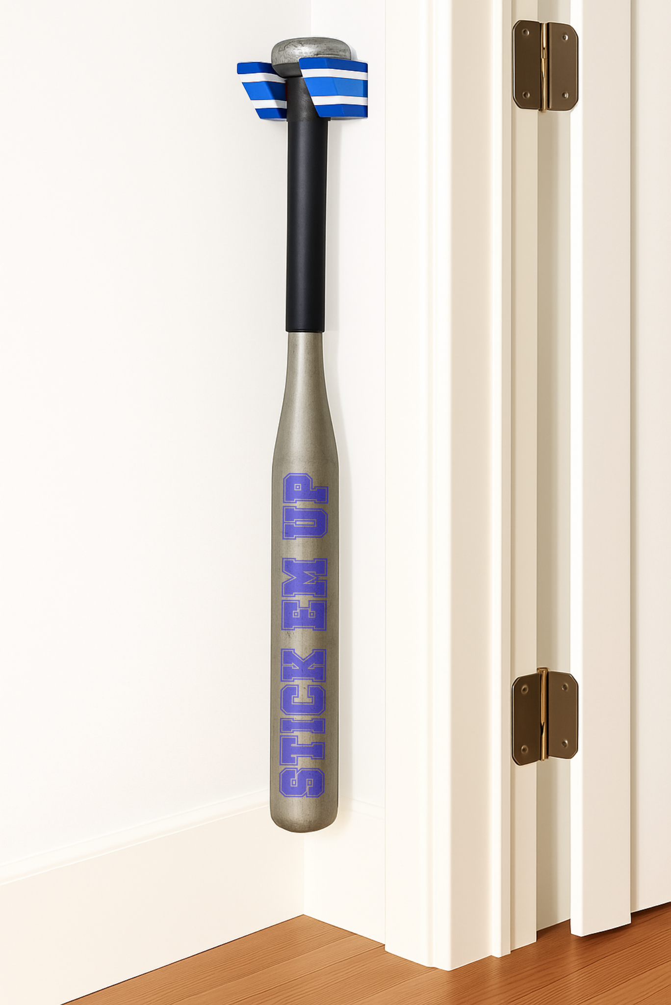 A Blue, White, and Blue Single Baseball Bat Holder Mounted against a wall near a doorframe.