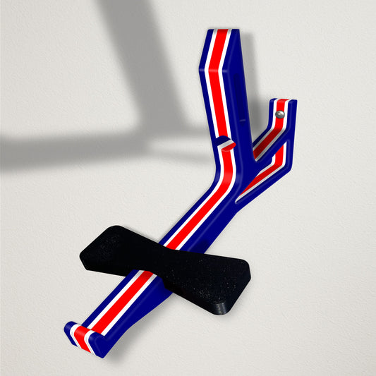 Angled baseball cap butler display organizer mount - navy with thin white accents and a thick red stripe on a clean wall